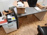 a desk with a box on top of it next to a filing cabinet