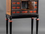 an image of a black and orange cabinet with drawers