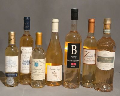 bottles of wine are lined up on a table with a gray background