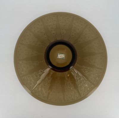 a brown vase with a black top on a white table
