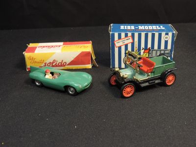 two toy cars that are sitting next to each other