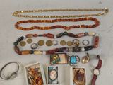 a lot of jewelry that is laying out on the table
