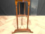 a small wooden table with a knife on top of it