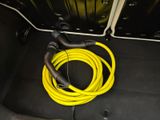 a yellow hose that is connected to a yellow hose in the trunk of a car