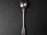 a spoon that is sitting on a black surface