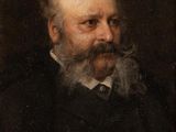 portrait of a man with a beard in a black suit and tie