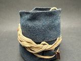 a small blue bag with a rope wrapped around it