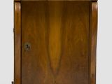 a small wooden cabinet with a drawer on top of it