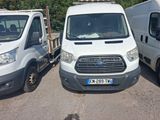 two white vans parked next to each other in a parking lot