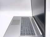 a silver laptop with a black keyboard on a white surface