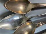 three spoons that are sitting next to each other on a table