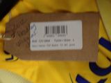 a tag on a yellow shirt that is on a table