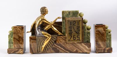 a statue of a man sitting on a bench with a clock