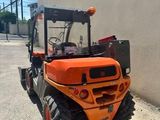 an orange construction vehicle parked on the side of the road