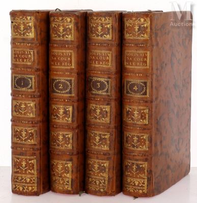 trois vieux livres posés l'un sur l'autre sur une surface blanche