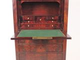 an old wooden desk with a green top and drawers