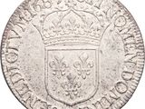 a silver coin with a crown on top of it