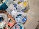 a pile of plastic bags on the floor next to a pile of other items