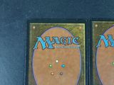 two decks of magic the gathering are sitting on a table