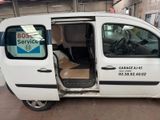 a small white van with the door open and a sign on the side of the van