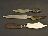 three knives are sitting next to each other on a table