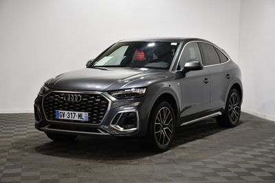 a grey audi suv parked in a room with a checkered floor