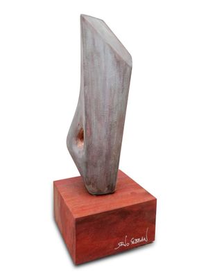 statue of a woman ' s foot on a wooden base