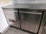 a stainless steel counter top in a kitchen with tile flooring