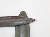 a knife that is laying on top of a wall