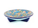bowl with a blue base and a floral design on the bottom