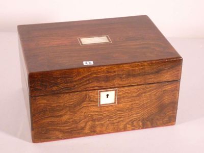an image of a small wooden box with a key on it