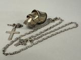 a silver bell with a cross and a chain around it