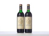 two bottles of wine sitting next to each other on a table