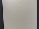 a piece of paper hanging on a black wall