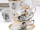 a lot of cups and saucers that are sitting on a table