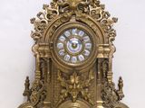 a gold clock sitting on top of a white table