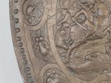 a large metal shield with a design on it