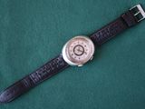 a watch that is sitting on a green cloth