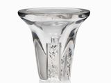 a glass vase that is sitting on a white surface