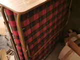a wooden table with a red and black checkered cloth on it