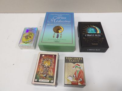 four books on the table and one is a tarot