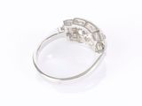 a close up of a diamond ring on a white surface