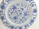 a blue and white plate with blue flowers on it