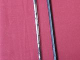 two swords that are on a red cloth