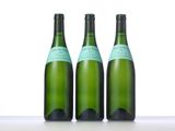 three bottles of wine sitting on top of a table next to each other