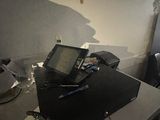 a laptop computer sitting on top of a desk in a room