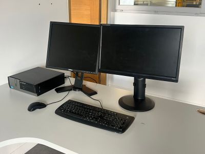 deux écrans d'ordinateur et un clavier sur un bureau