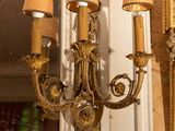 a picture of a wall sconce with a mirror in the background