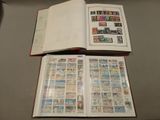 an open book with stamps on it sitting on top of a table