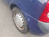 a blue car that is parked on the side of the street